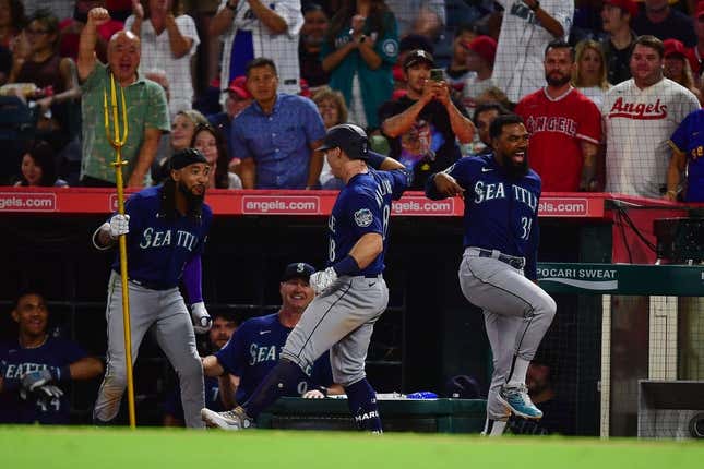 August 3, 2023; Anaheim, California, USA; Seattle Mariners left fielder Cade Marlowe (18) is greeted by shortstop J.P. Crawford (3) and designated hitter Teoscar Hernandez (35) after hitting a grand slam home run against the Los Angeles Angels during the ninth inning at Angel Stadium.