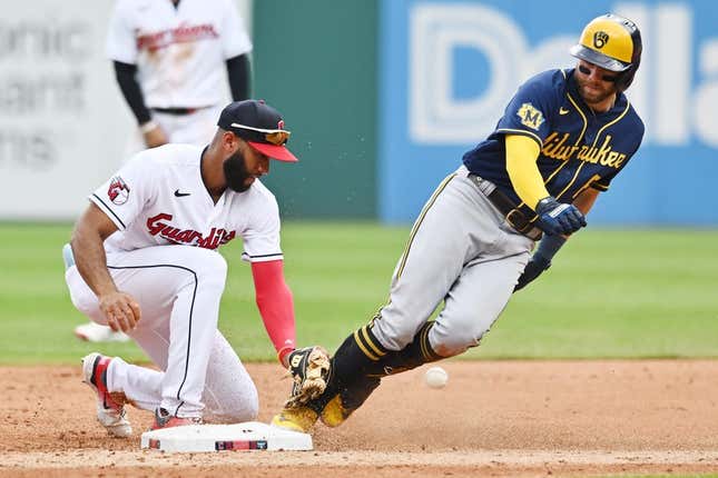 Jun 25, 2023; Cleveland, Ohio, USA; Milwaukee Brewers third baseman Owen Miller (6) is safe at second with an RBI double as Cleveland Guardians shortstop Amed Rosario (1) can not handle the throw during the third inning at Progressive Field.