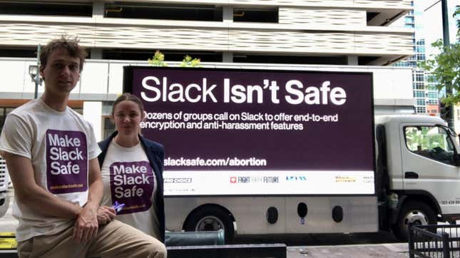 Protesters in front of a mobile billboard reading "Slack Isn't Safe"