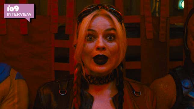 Margot Robbie's Harley Quinn is bathed in red light and looking surprised in The Suicide Squad.