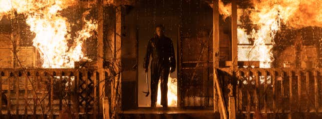 Michael Myers stands in a fiery inferno in a still from Halloween Kills.
