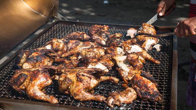 Black chef grilling barbecue chicken