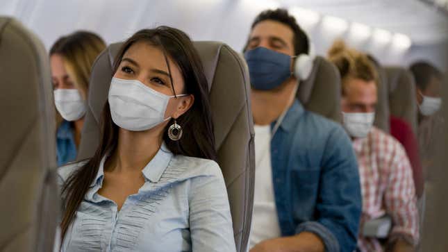 masked passengers in airplane
