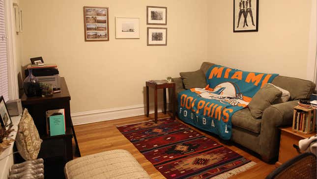 Image for article titled Carefully Thought-Out Living Room Decor Overshadowed By Enormous Blanket With Team Logo On It