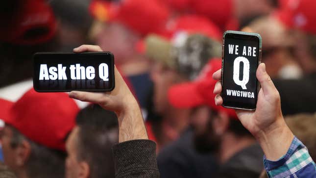 Trump supporters waving Q messages on their phones at a Trump rally in Las Vegas on February 22, 2020.