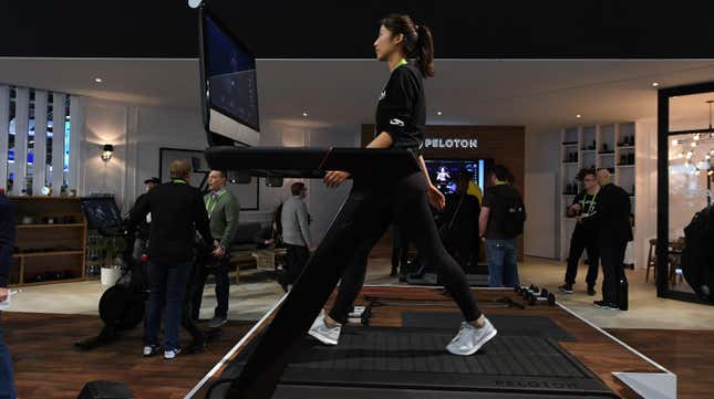 A woman demonstrates the Peloton Tread+ at CES 2018 in Las Vegas.