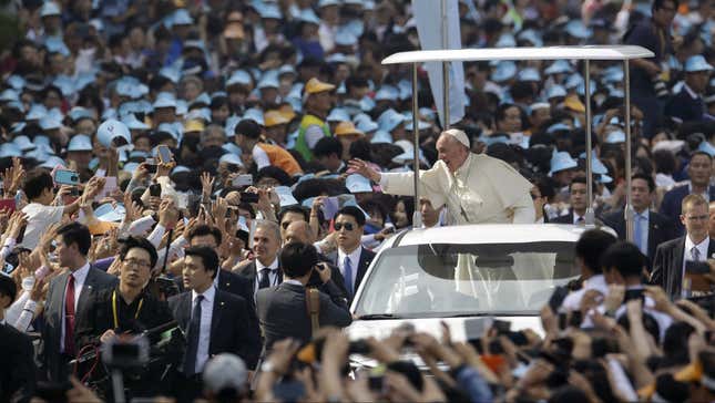 Pope Francis waves to crowds in Seoul on August 16.