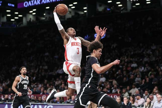 Mar 29, 2023; Brooklyn, New York, USA;  Houston Rockets guard Kevin Porter Jr. (3) goes past Brooklyn Nets forward Cameron Johnson (2) for a dunk attempt in the second quarter at Barclays Center.