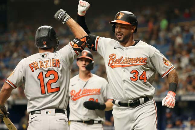 Jun 20, 2023; St. Petersburg, Florida, USA;  Baltimore Orioles left fielder Aaron Hicks (34) celebrates with second baseman Adam Frazier (12) after he hits a 3-run home run against the Tampa Bay Rays during the first inning at Tropicana Field.