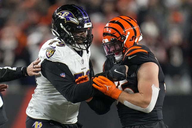 Jan 15, 2023; Cincinnati, Ohio, USA; Baltimore Ravens offensive tackle Ronnie Stanley (79) grips the jersey of Cincinnati Bengals linebacker Logan Wilson (55) after a play in the fourth quarter during an NFL wild-card playoff football game between the Baltimore Ravens and the Cincinnati Bengals at Paycor Stadium.
