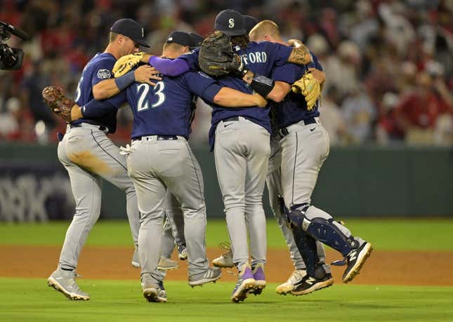 Aug 4, 2023; Anaheim, California, USA;  Seattle Mariners players dance in a circle after defeating the Los Angeles Angels at Angel Stadium.