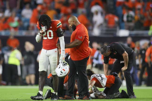 Sep 9, 2023; Miami Gardens, Florida, USA; Miami Hurricanes safety James Williams (20) reacts as trainers check on Miami Hurricanes safety Kamren Kinchens (5) after an injury against the Texas A&amp;amp;M Aggies during the fourth quarter at Hard Rock Stadium.