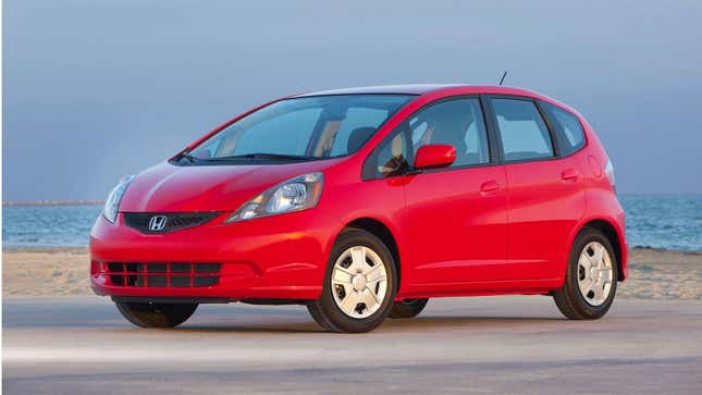 A photo of a red Honda Fit hatchback. 