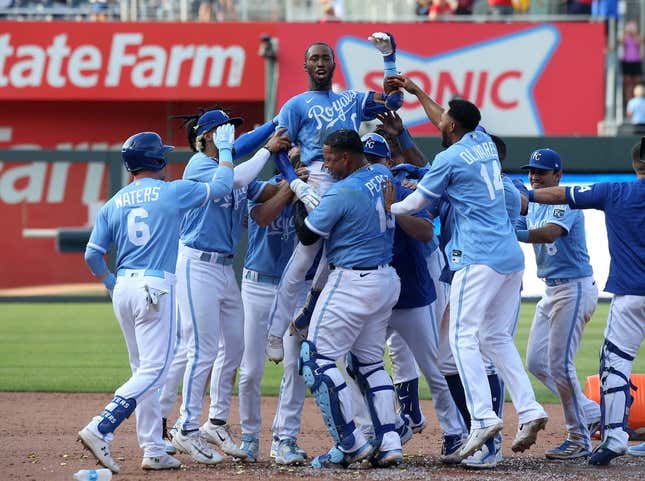 Jun 17, 2023; Kansas City, Missouri, USA; Kansas City Royals left fielder Samad Taylor (0) is lifted in the air by teammate Salvador Perez (13) after Taylor hit the game-winning single in his major league debut against the Los Angeles Angels at Kauffman Stadium.