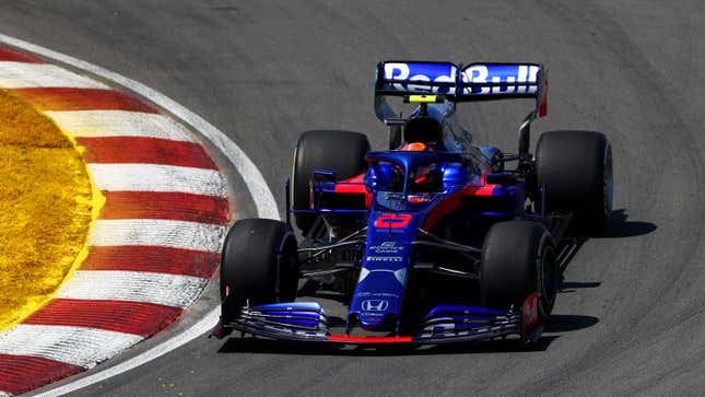 A photo of Alex Albon driving the blue and red Toro Rosso F1 car. 