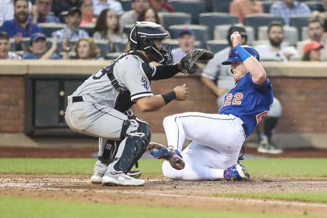 Jul 19, 2023; New York City, New York, USA;  New York Mets third baseman Brett Baty (22) slides safely past Chicago White Sox catcher Carlos Perez (36) in the fourth inning at Citi Field.