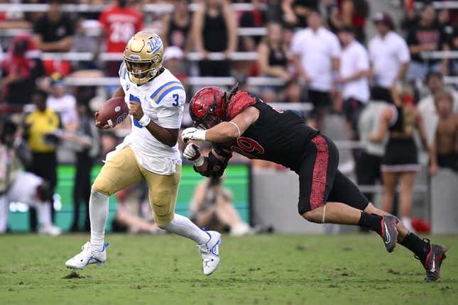 Sep 9, 2023; San Diego, California, USA; UCLA Bruins quarterback Dante Moore (3) runs the ball while defended by San Diego State Aztecs defensive lineman Garret Fountain (39) during the first half at Snapdragon Stadium.