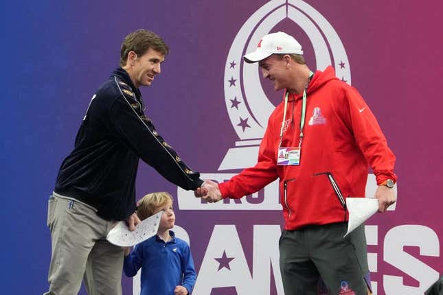 Feb 5, 2023; Paradise, Nevada, USA; NFC captain Eli Manning (left) and AFC captain Peyton Manning shake hands during the Pro Bowl Games at Allegiant Stadium.