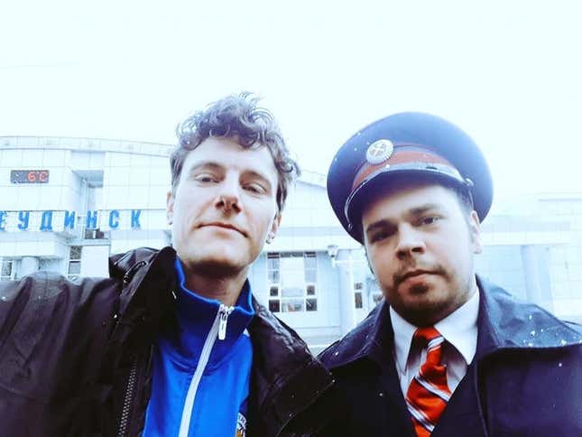 The author of this story, Roger Tyers, meeting a train guard in Siberia