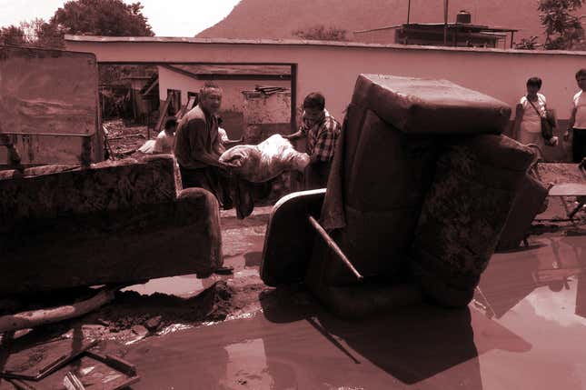 Residents clean up the day after torrential rain waters flooded the town of Nogales, 205 km (125 miles) southeast of Mexico City, Mexico, Friday, June 6, 2003. Fifteen people were missing Friday from the flooding and explosions that rocked the area, according to the Nogales municipal police department. Flooding leveled 10 houses in Nogales alone. At least two people were killed and 80 injured, but the toll was expected to rise.