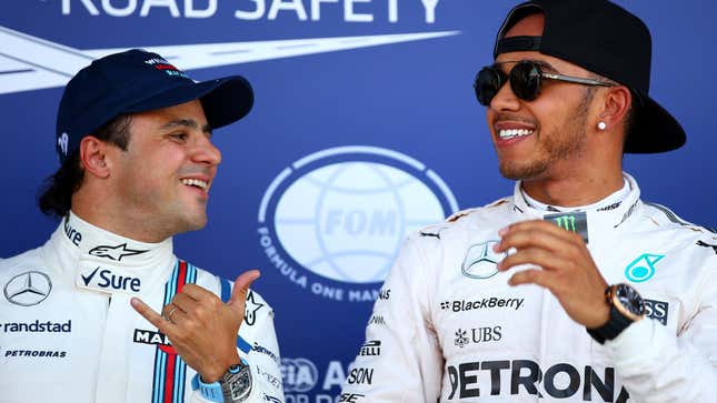 Lewis Hamilton of Great Britain and Mercedes GP celebrates in Parc Ferme next to Felipe Massa of Brazil and Williams after claiming pole position during qualifying for the Formula One Grand Prix of Great Britain at Silverstone Circuit