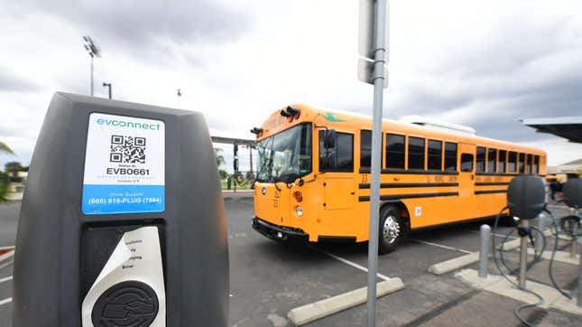 A new EV school bus from an all-electric fleet is parked beside charging stations at South El Monte High School on August 18, 2021 in El Monte, California.