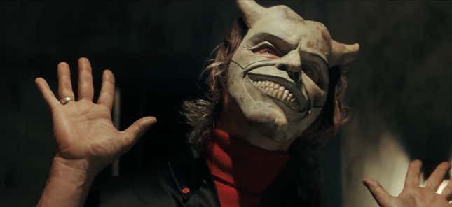 Ethan Hawke wears a white mask with horns in a scene from The Black Phone.