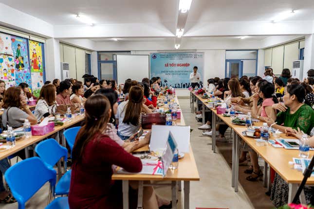 OneSky caregivers sit in a training session in Da Nang