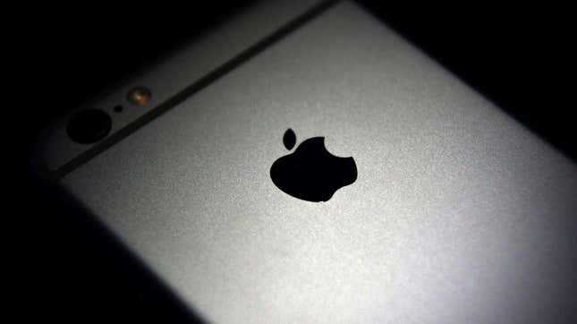 A photo of the Apple logo on the back of an iPhone