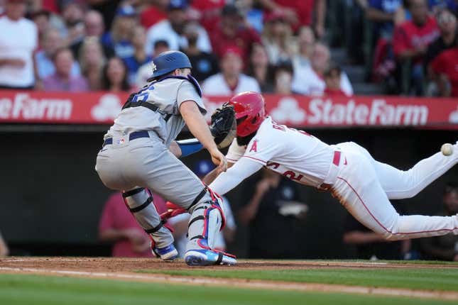 Jun 21, 2023; Anaheim, California, USA; Los Angeles Angels third baseman Luis Rengifo (2) is tagged out at home plate by Los Angeles Dodgers catcher Will Smith (16) in the third inning at Angel Stadium.