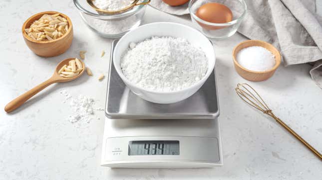 Kitchen scale with a bowl of flour on top.