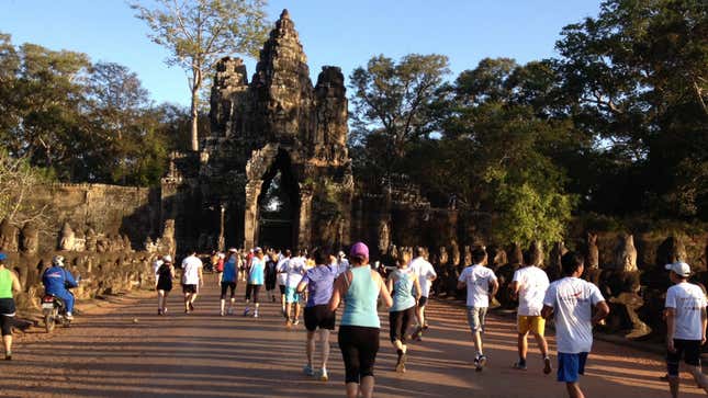 Runners in the 10K part of the Angkor Wat race make their way through Angkor Thom gate.