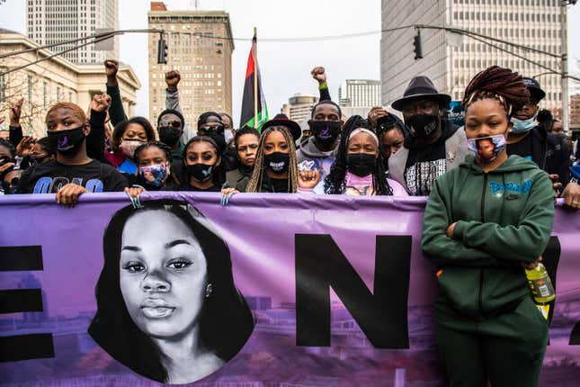 Tamika Mallory, Tamika Palmer, Breonna’s mom, Benjamin Crump and Kenneth Walker, Breonna’s boyfriend, along with other protestors hold a banner during in front ofa march on the One Year Anniversary of the death of Breonna Taylor on March 13, 2021 in Louisville, Kentucky. 