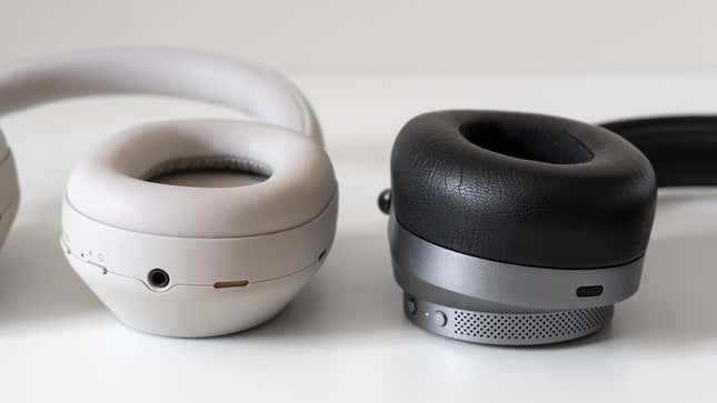 A close-up of a Sony WH-1000XM5's ear cup next to a Master & Dynamic MW75 ear cup.
