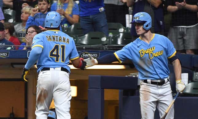 Aug 25, 2023; Milwaukee, Wisconsin, USA; Milwaukee Brewers first baseman Carlos Santana (41) scores a run against the San Diego Padres and is congratulated by Milwaukee Brewers left fielder Mark Canha (21) in the seventh inning at American Family Field.
