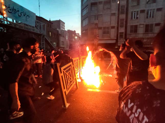 In this Wednesday, Sept. 21, 2022, photo taken by an individual not  employed by the Associated Press and obtained by the AP outside Iran,  protesters make fire and block the street during a protest over the  death of a woman who was detained by the morality police, in downtown  Tehran, Iran. 