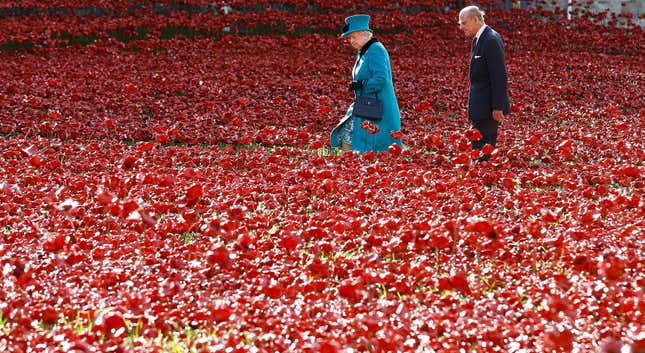 Britain's Queen Elizabeth II, left, and the Duke of Edinburgh walk through the field of ceramic poppies at The Tower of London, Thursday, Oct. 16, 2014. The poppies are part of a ceramic poppy installation called 'Blood Swept Lands and Seas of Red' which marks the centenary of the outbreak of the First World War. (AP Photo/Kirsty Wigglesworth)