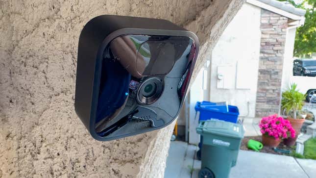 Blink outdoor security camera mounted on the side of a house
