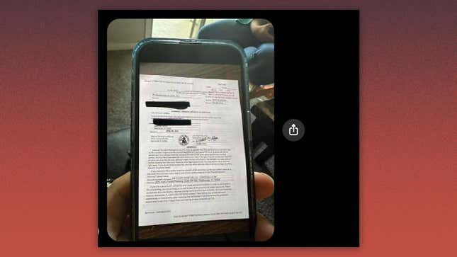 Image with phone showing photo of summons