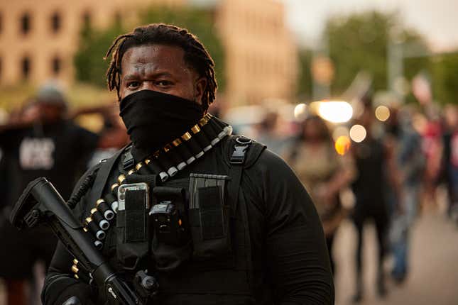 An armed demonstrator stands guard during a vigil in honor of Jayland Walker on July 8, 2022 in Akron, Ohio. Walker was shot and killed by members of the Akron Police Department on July 3, 2022.