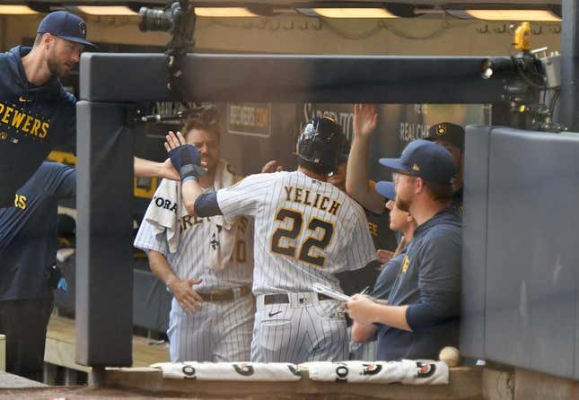 Jul 9, 2023; Milwaukee, Wisconsin, USA; Milwaukee Brewers left fielder Christian Yelich (22) celebrates in the dugout after scoring a run against the Cincinnati Reds in the first inning at American Family Field.