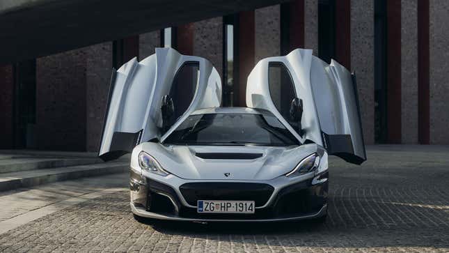 A photo of a Rimac Nevera electric supercar with its doors open. 