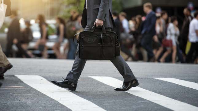 Man in crosswalk holding briefcase