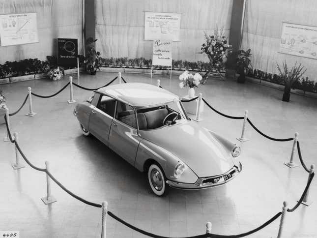 A 1956 Citroen ID parked behind a velvet rope.