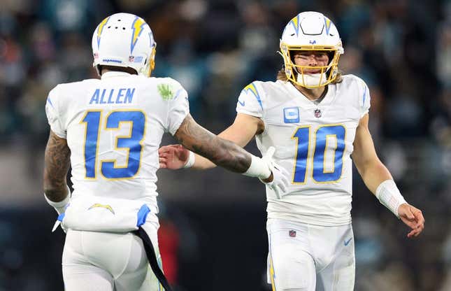 Jan 14, 2023; Jacksonville, Florida, USA; Los Angeles Chargers quarterback Justin Herbert (10) and wide receiver Keenan Allen (13) celebrate after a play during the second quarter a wild card game against the Jacksonville Jaguars at TIAA Bank Field.