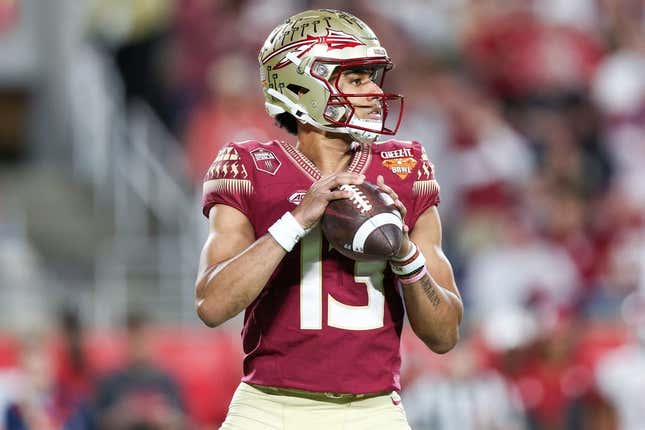 Dec 29, 2022; Orlando, Florida, USA; Florida State Seminoles quarterback Jordan Travis (13) drops back to pass against the Oklahoma Sooners in the second quarter during  the 2022 Cheez-It Bowl at Camping World Stadium.