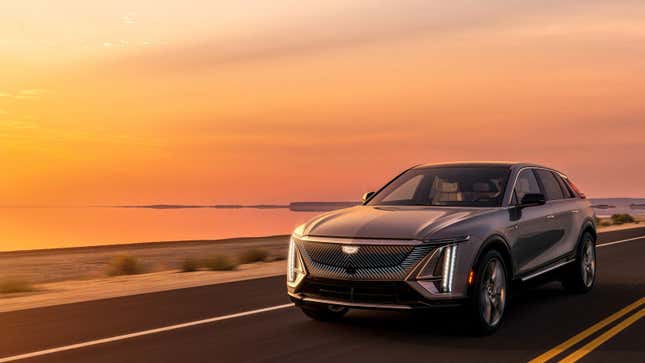 A photo of the 2023 Cadillac Lyriq EV driving at sunset. 