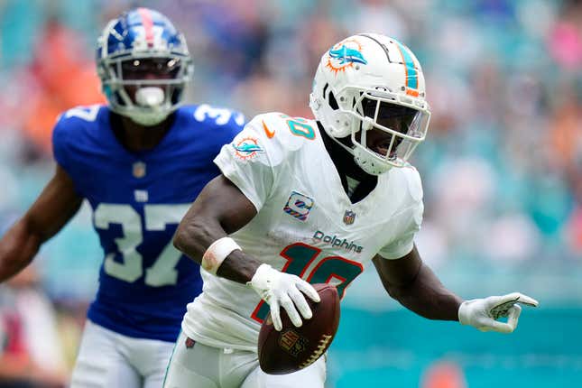 MIAMI GARDENS, FLORIDA - OCTOBER 08: Tyreek Hill #10 of the Miami Dolphins scores a touchdown against the New York Giants during the third quarter at Hard Rock Stadium on October 08, 2023 in Miami Gardens, Florida. (Photo by Rich Storry/Getty Images)