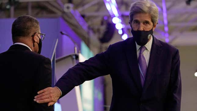 John Kerry, United States Special Presidential Envoy for Climate, right, touches the arm of Alok Sharma President of the COP26 summit during a stocktaking plenary session at the COP26 U.N. Climate Summit in Glasgow, Scotland on Saturday.