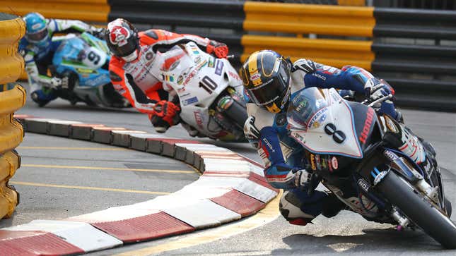 A photo of motorbikes racing on a track. 